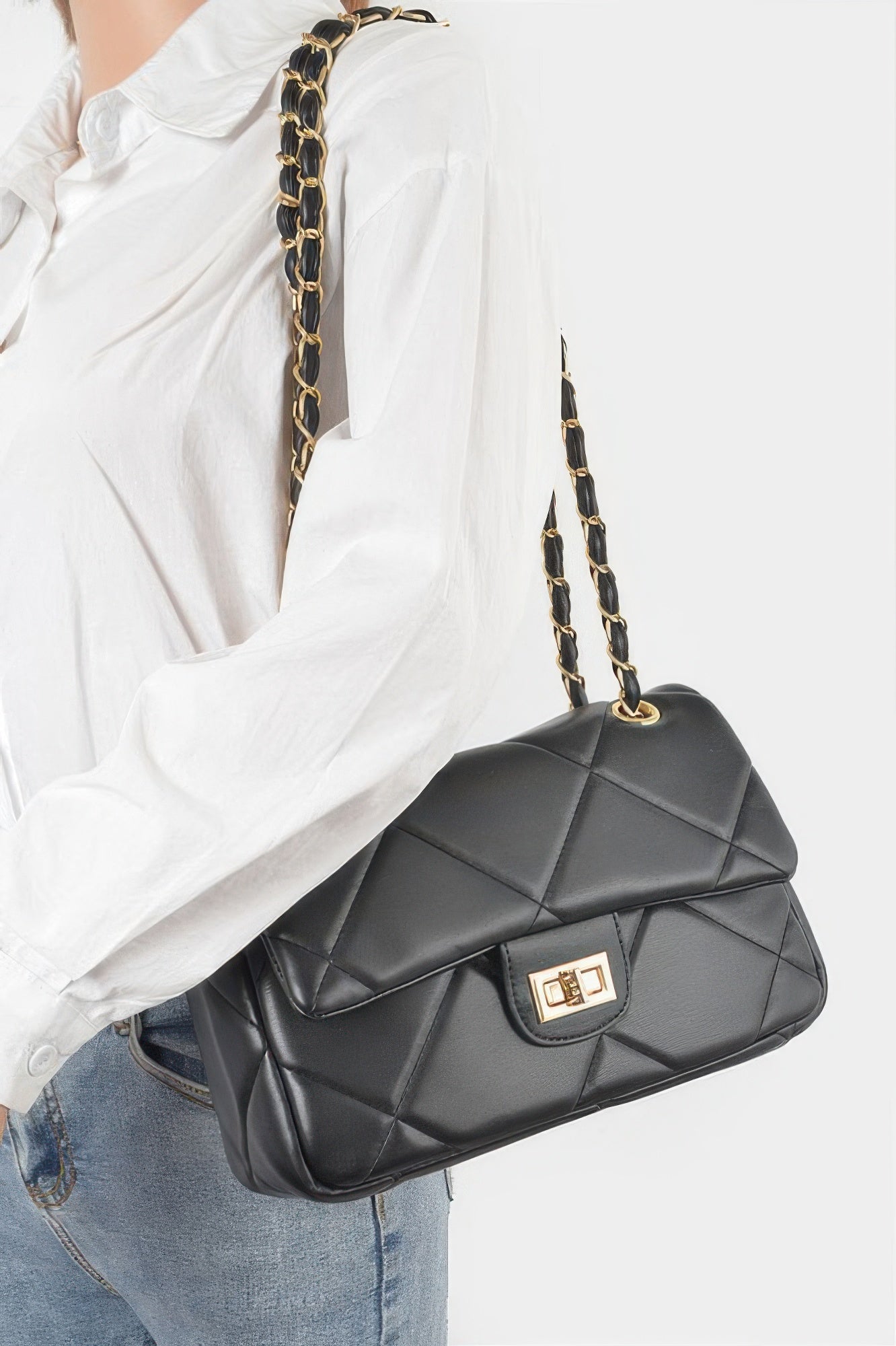 Golden Heir wide quilted shoulder bag in white with gold accents, featuring a spacious design and comfortable shoulder strap.