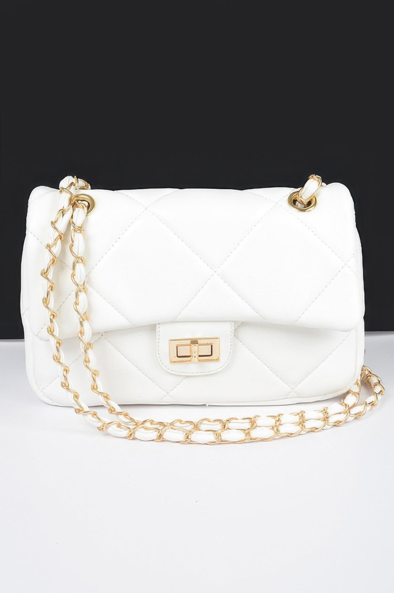 Golden Heir wide quilted shoulder bag in white with gold accents, featuring a stylish and spacious design.