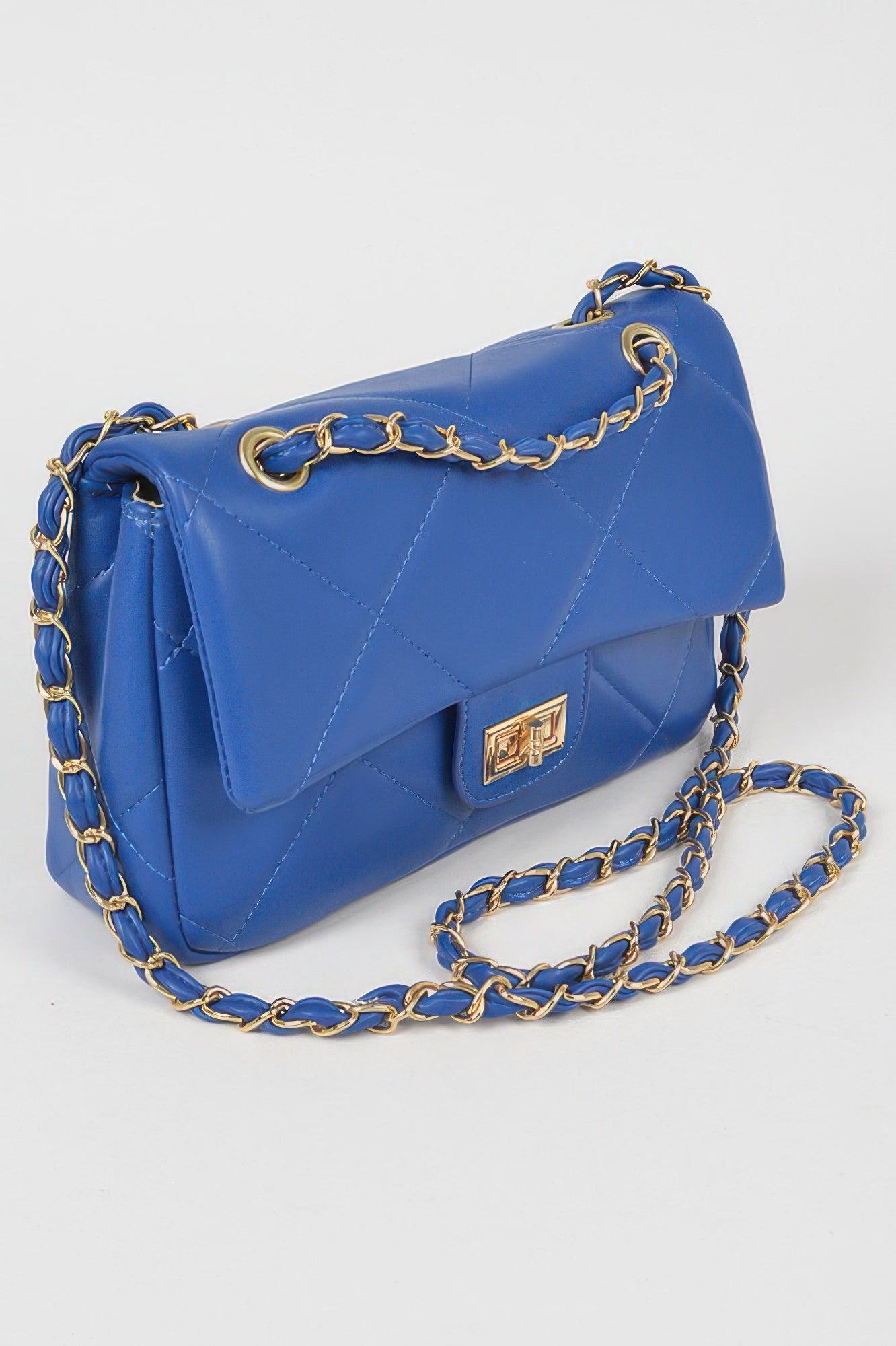 Golden Heir wide quilted shoulder bag in white with gold accents, featuring a stylish and spacious design.