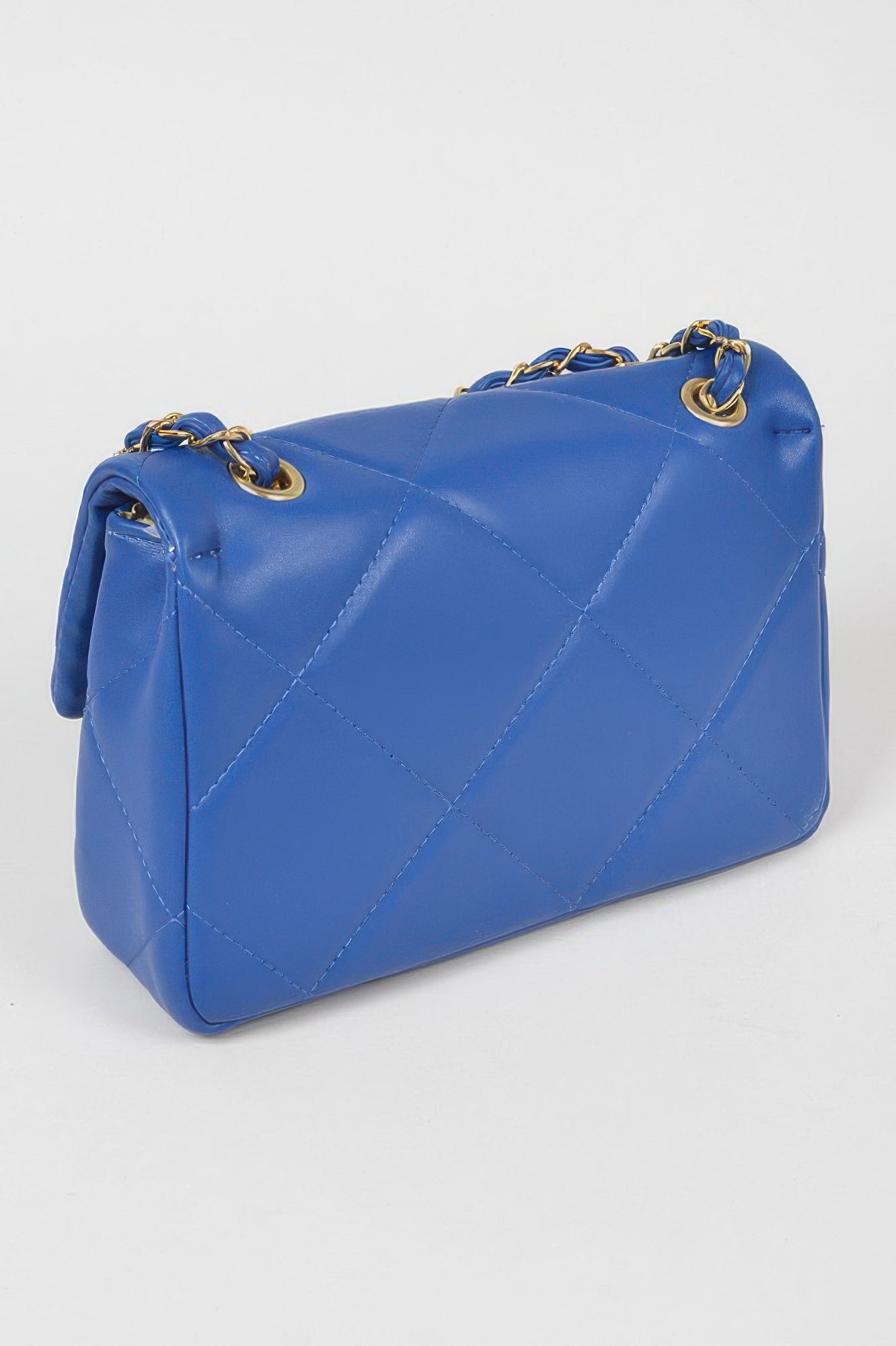 Golden Heir wide quilted shoulder bag in white with gold accents, featuring a stylish and spacious design.