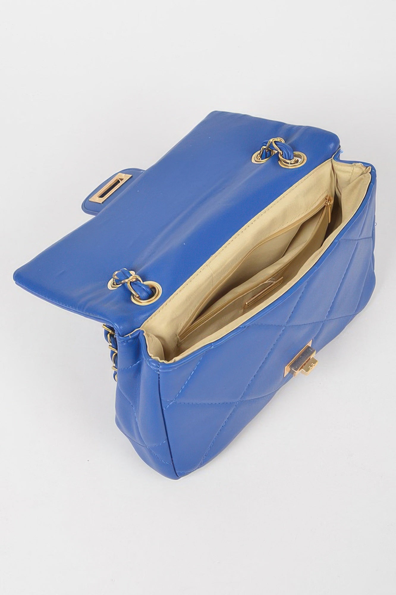 Golden Heir wide quilted shoulder bag in white with gold accents, featuring a stylish, spacious design for everyday use.