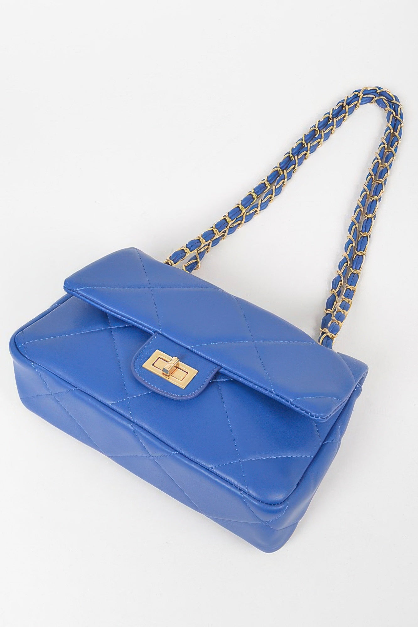 Golden Heir wide quilted shoulder bag in white with gold accents, featuring a stylish, spacious design for everyday use.