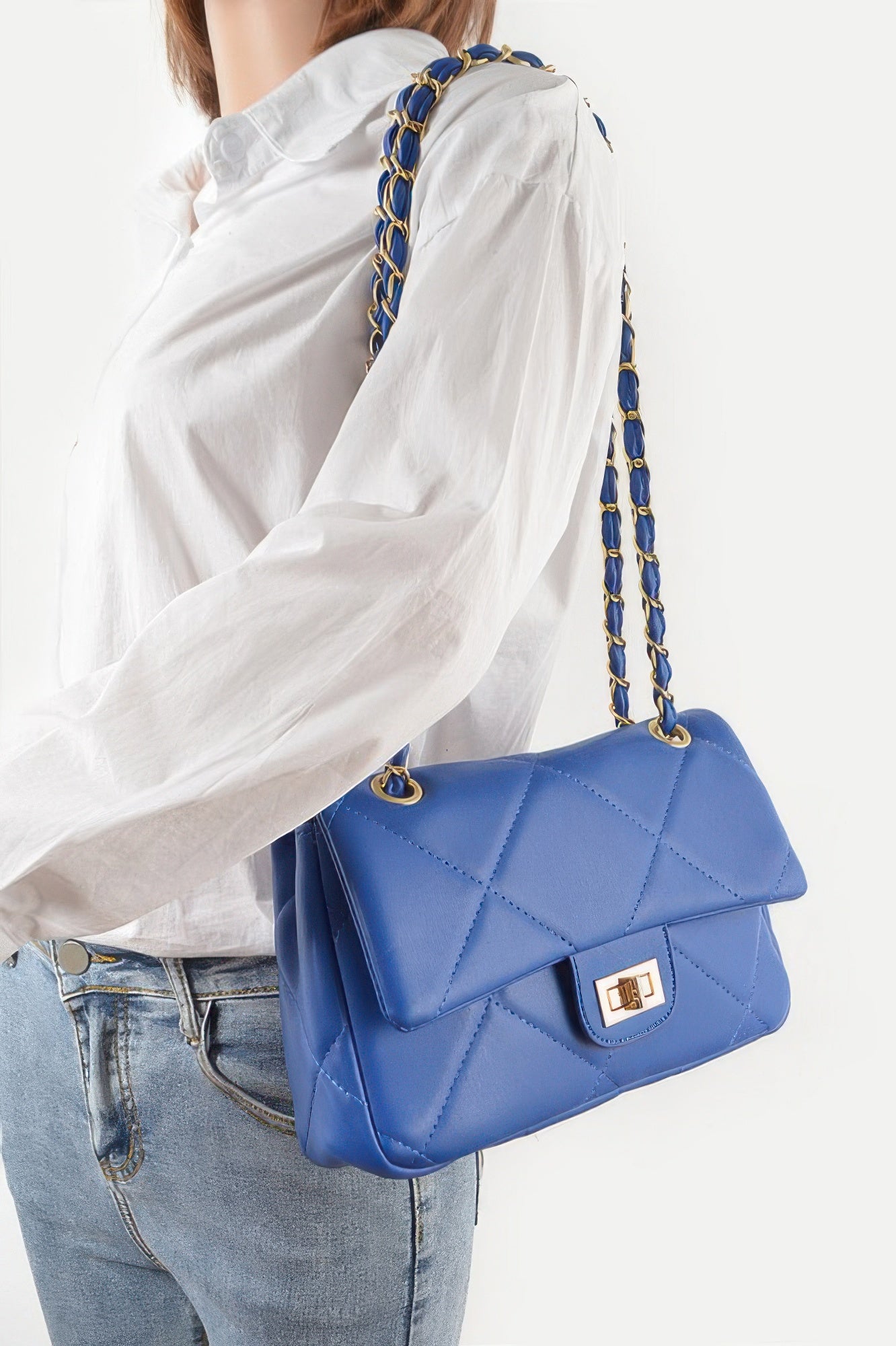Golden Heir wide quilted shoulder bag in white with gold accents, featuring a stylish and spacious design.