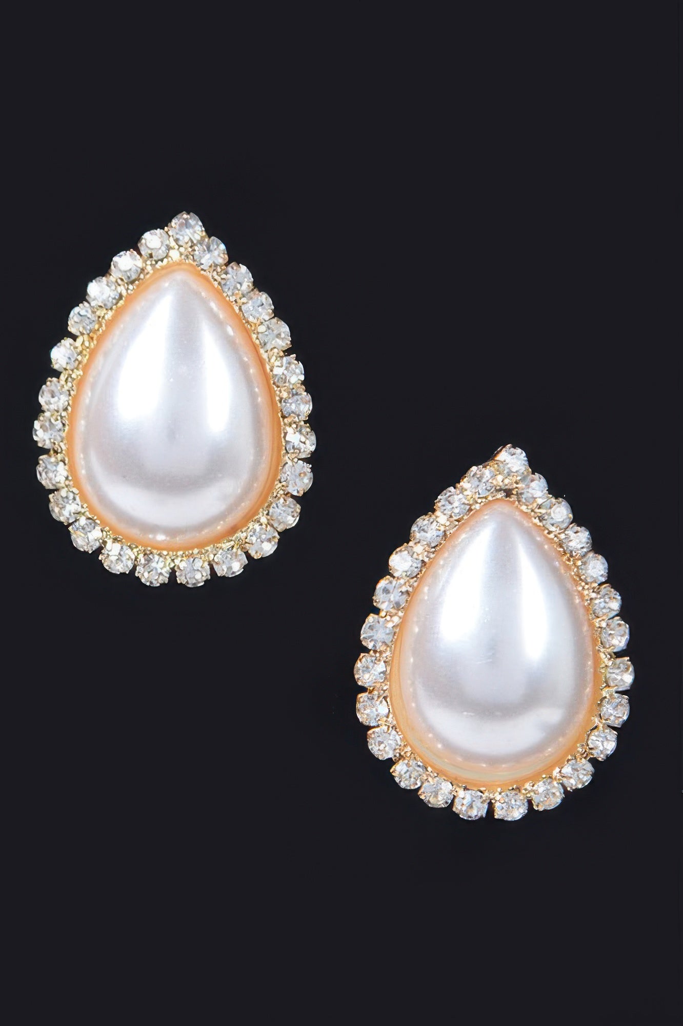 Golden Heir teardrop pearl stud earrings featuring elegant gold setting and classic pearl design.