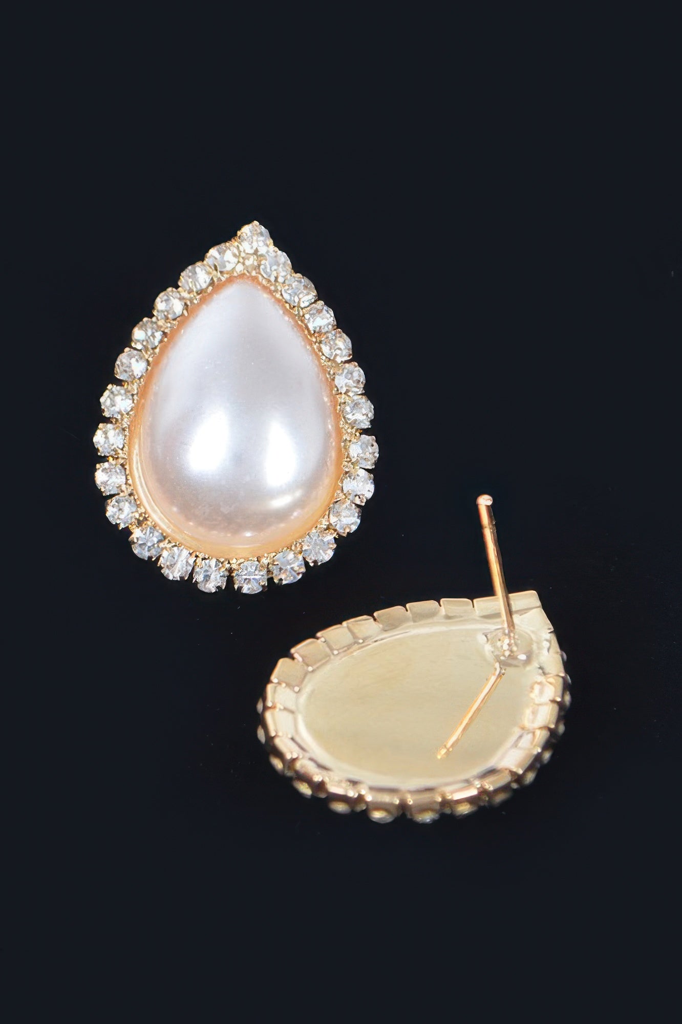 Golden Heir teardrop pearl stud earrings in gold with classic design, showcasing elegant pearl accents and shiny gold setting.