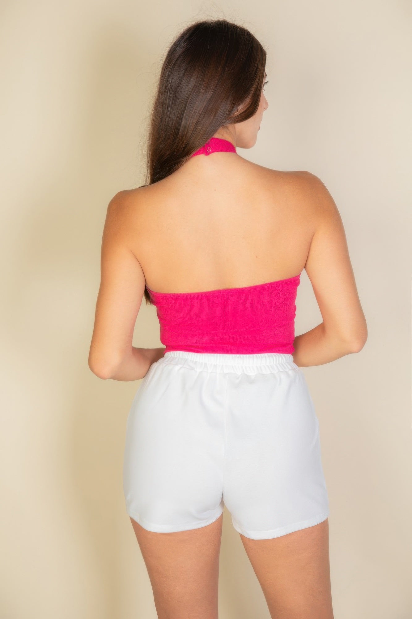 Black Golden Heir ribbed halter neck backless tank top, close-up of the fitted design and textured fabric.