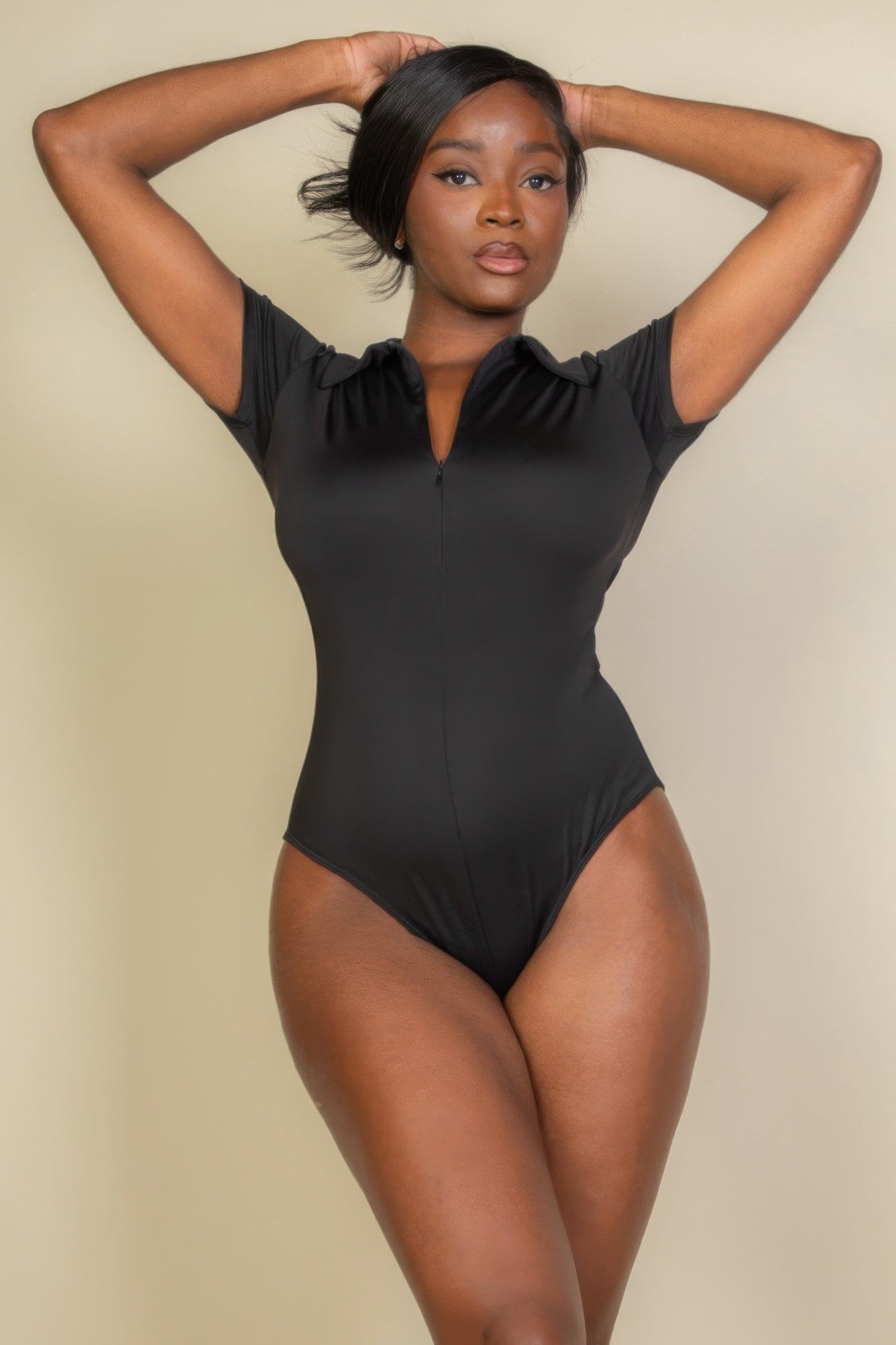 Black Golden Heir sculpted zip front short sleeve bodysuit, close-up of fitted design and front zipper detail.